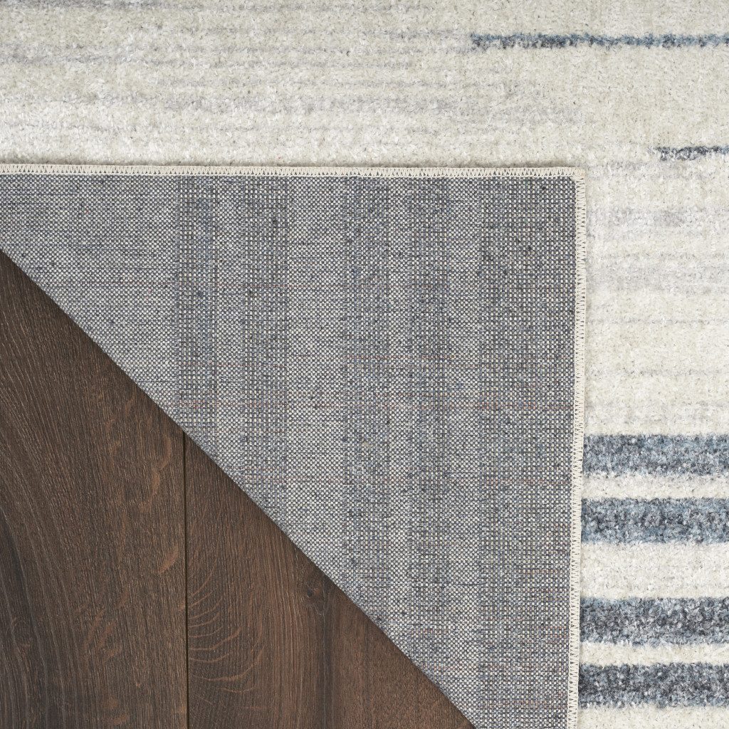 5′ X 7′ Blue and Ivory Geometric Washable Area Rug